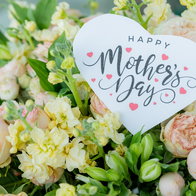 Bouquet of flowers with a “Happy Mother’s Day” card celebrating the occasion in Spain