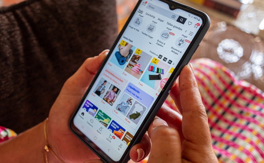 Woman shopping online on her smartphone while browsing discounts and flash sales on an ecommerce app.
