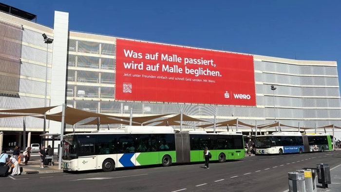 Large Wero advertising billboard displayed on the parking structure at Palma de Mallorca Airport, the campaign at the centre of a political controversy over tourism image.
