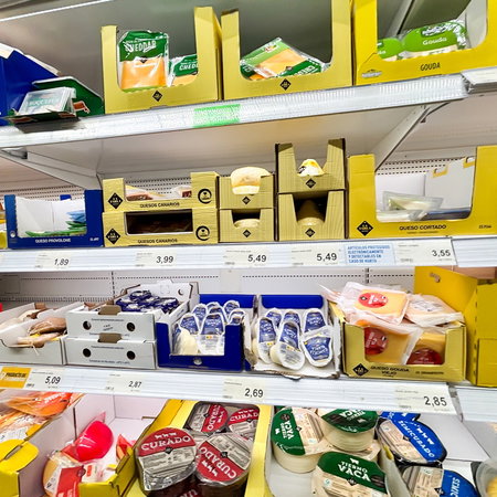 Cheese products displayed on supermarket shelves in Spain following a nationwide Listeria food alert involving fresh cheeses.