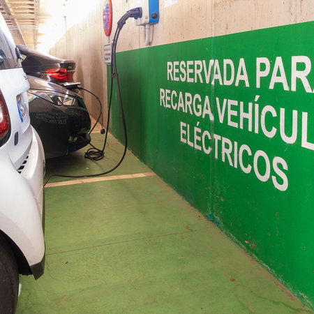 Electric vehicles charging in a reserved EV charging area in Spain as the country expands its rapid charging network.