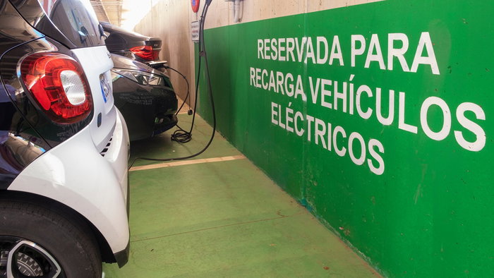 Electric vehicles charging in a reserved EV charging area in Spain as the country expands its rapid charging network.