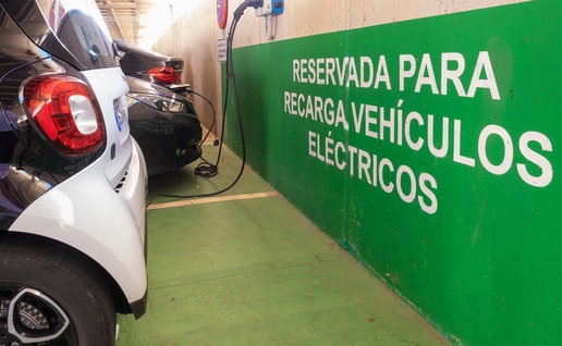 Electric vehicles charging in a reserved EV charging area in Spain as the country expands its rapid charging network.