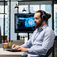 Man working on a computer using artificial intelligence tools in a modern office environment in Spain
