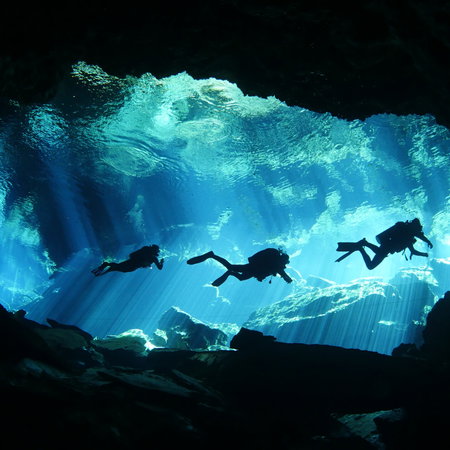 Scuba divers in an underwater cave