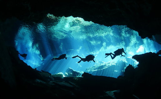 Scuba divers in an underwater cave