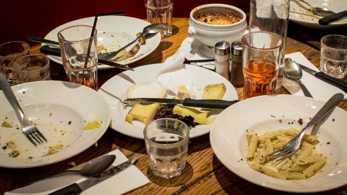 Empty plates on a dinner table at a restaurant