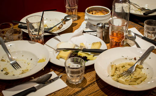 Empty plates on a dinner table at a restaurant