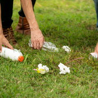 Young people collecting rubbish off the floor