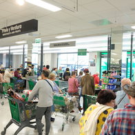 Shoppers in a supermarket waiting to pay at the checkout