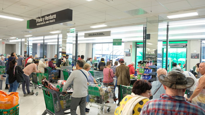 Shoppers in a supermarket waiting to pay at the checkout
