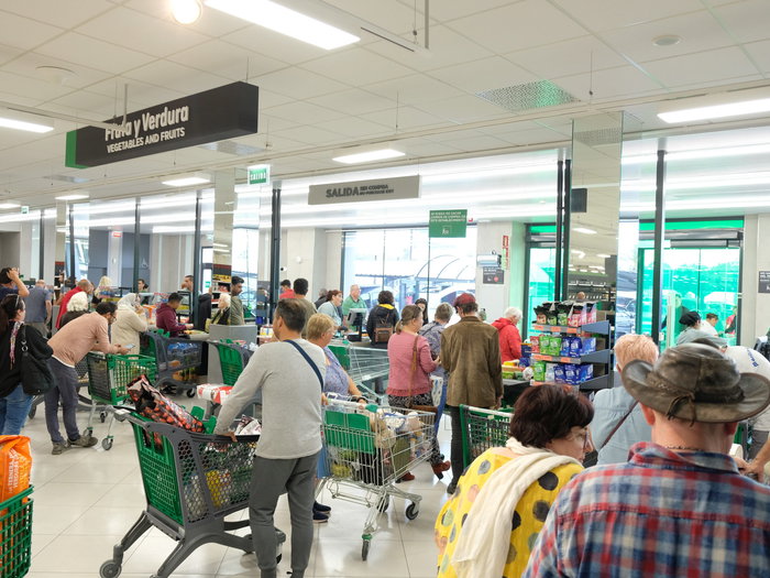 Shoppers in a supermarket waiting to pay at the checkout