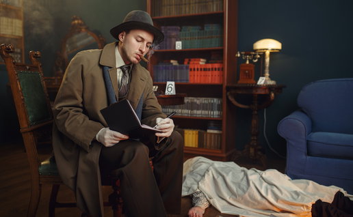 Male detective with cigar writes in notebook