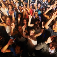 Music, dance and party with crowd at concert for rock, live band performance or festival. New year, energy and disco with audience of fans listening at celebration for techno, rave or nightclub event