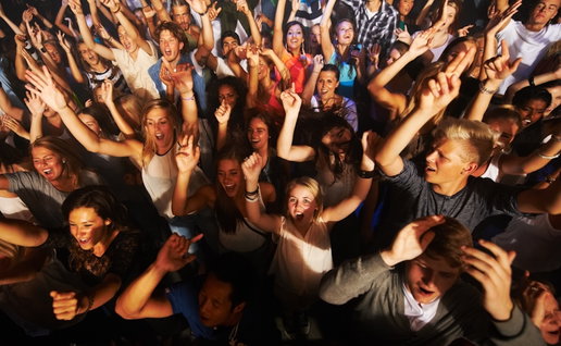 Music, dance and party with crowd at concert for rock, live band performance or festival. New year, energy and disco with audience of fans listening at celebration for techno, rave or nightclub event