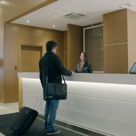 Man checking in at the reception of a hotel
