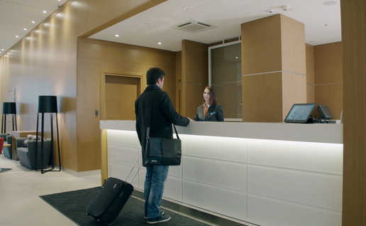 Man checking in at the reception of a hotel