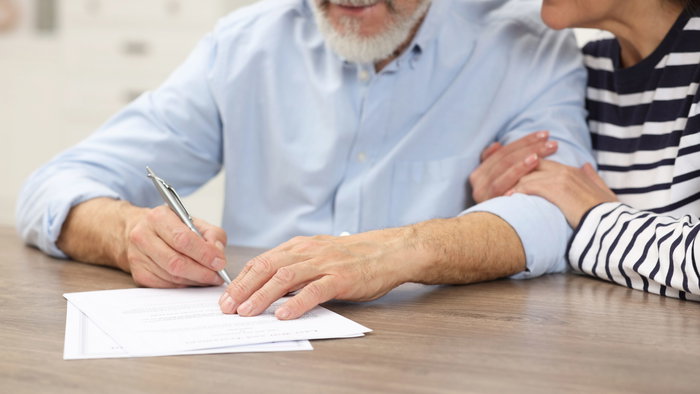 Signing a will.