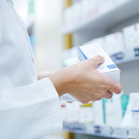 A pharmacists holding medication