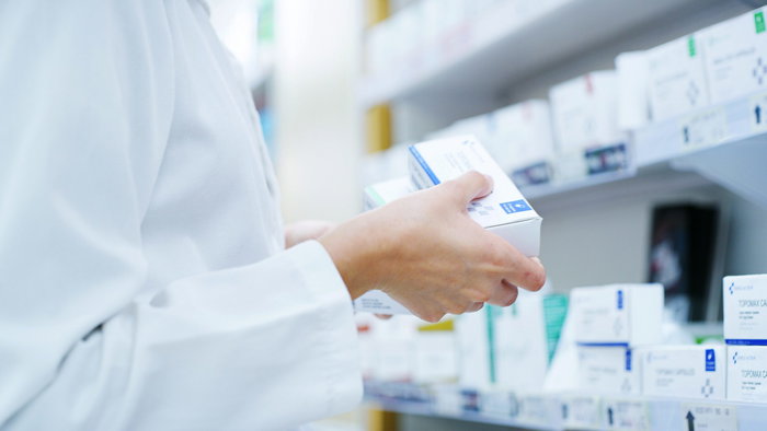 A pharmacists holding medication