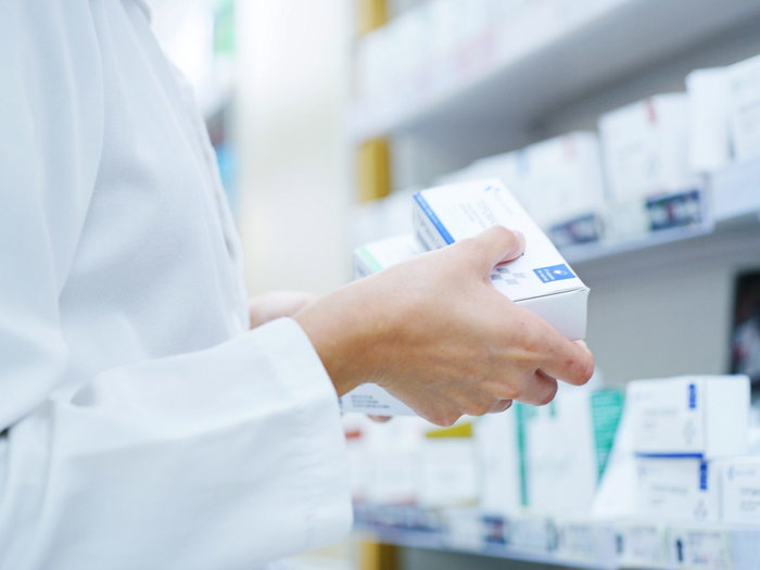 A pharmacists holding medication