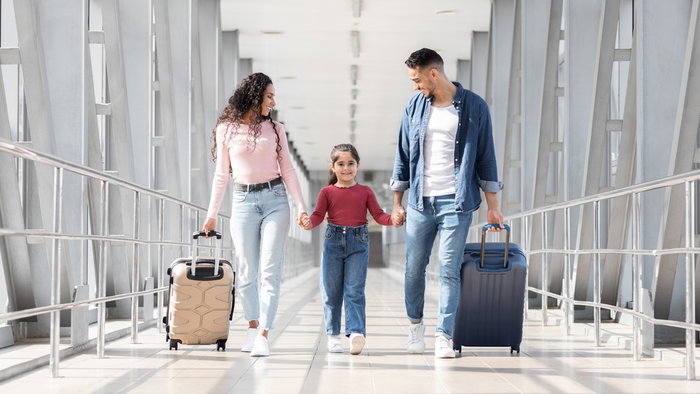 A family of three at the arirport.