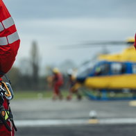 Helicopter paramedics standing by a helicopter
