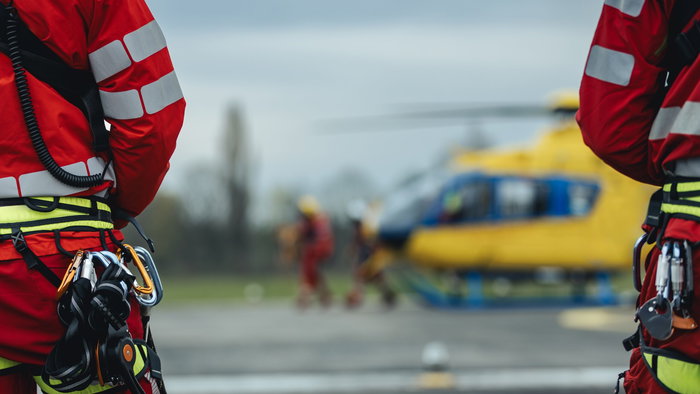 Helicopter paramedics standing by a helicopter
