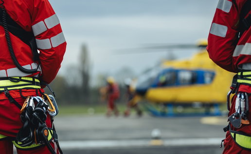 Helicopter paramedics standing by a helicopter
