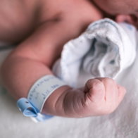 Arm of a new born babies with an ID tag around his wrist