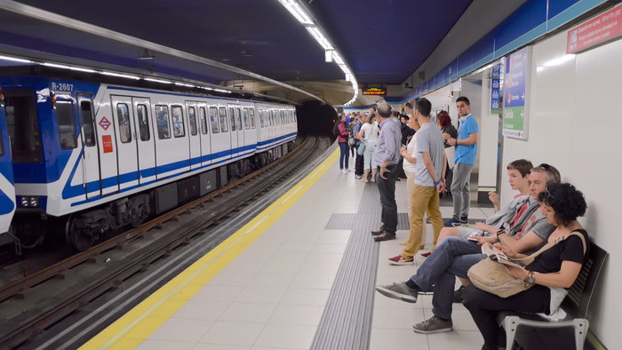 Passengers waiting for a train in the metro of Madrid