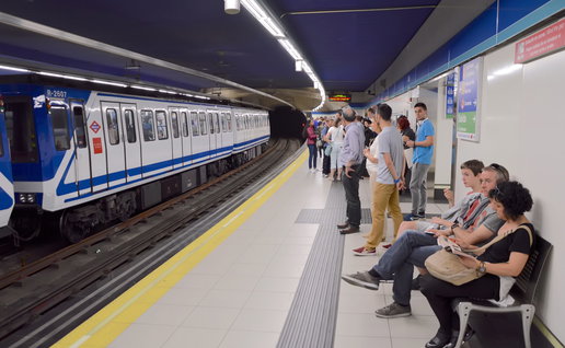Passengers waiting for a train in the metro of Madrid
