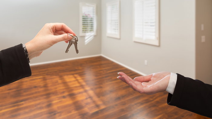 Keys being handed over inside an empty apartment as Spain launches payments for owners of vacant properties.