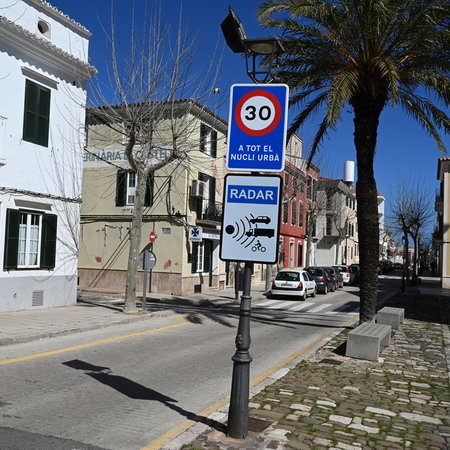 Radar speed camera warning sign on a residential street in Spain with a 30 km/h speed limit displayed.