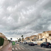 Dark storm clouds gathering over a residential street in Spain as unstable weather moves across the country.