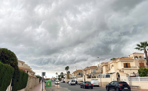 Dark storm clouds gathering over a residential street in Spain as unstable weather moves across the country.