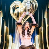 Dara lifts the 2026 Eurovision trophy.