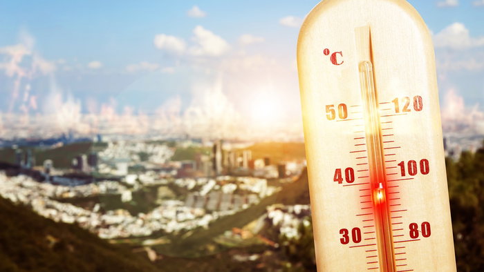 Thermometer showing extreme heat above 40C overlooking a Spanish city during unusually high summer temperatures.