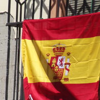 A flag hanging on a balcony.