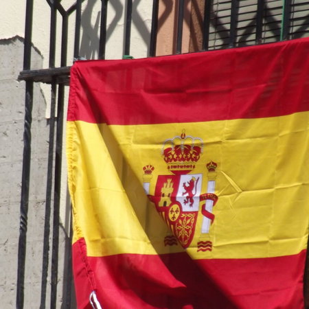 A flag hanging on a balcony.
