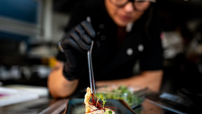 A chef from Gastro Moon Restaurante in Almoradi putting the finishing touches to a dish.