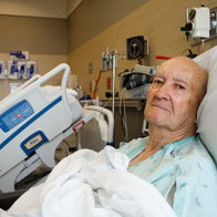 Patient Sitting Up in Modern Hospital Room