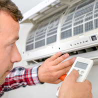 Man setting up an air-conditioning unit.
