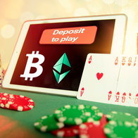 Tablet screen showing a bitcoin symbol with hearts playing cards at the side