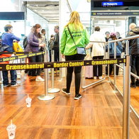 Travellers queue at a European airport border control checkpoint following the launch of new EU migration, visa and identity verification systems.