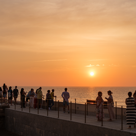 Busy promenade at sunset.