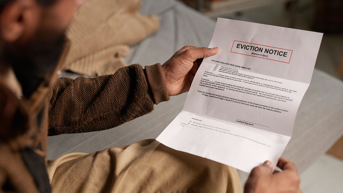 Man holding an eviction notice