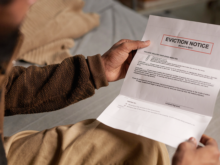 Man holding an eviction notice