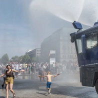 Crowd control: Berlin police deploy water cannon to cool people down.