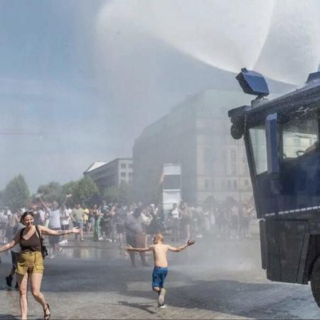 Crowd control: Berlin police deploy water cannon to cool people down.